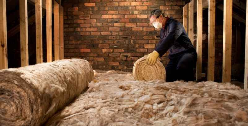 Technician removing loft insulation